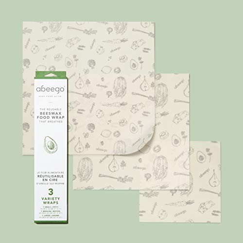 Abeego set of 3 original beeswax food storage wrap size 7, 10, 13 inch natural square sheets on a green background Danielle Walker