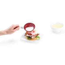  Cuisipro egg silicone poacher set of 2 in red - product image of a poached egg being placed on a sandwich Danielle Walker
